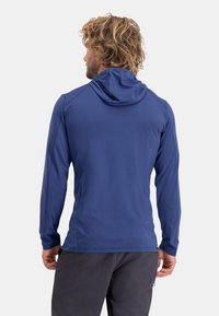 Navy blue hooded long-sleeve shirt with a smooth texture, featuring seam detailing and a fitted design for active wear.