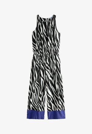 Salopetă cu dungi în alb și negru, fără mâneci, cu talie elastică și tiv solid albastru în partea de jos. Material ușor.