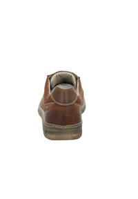 Brown leather shoe with a rounded toe, stitched detailing, and a rubber sole. Interior has a light fabric lining. Back view only.