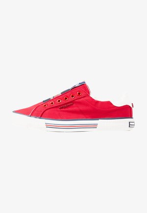 Red canvas sneakers with white accents, featuring metal eyelets, a textured white sole, and horizontal red, white, and blue stripes.