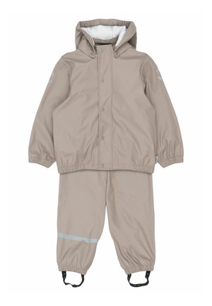 Béžová nepremokavá bunda s kapucňou a elastickými manžetami, v kombinácii s nohavicami rovnakej farby s reflexným pruhom a nastaviteľnými popruhmi.
