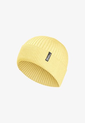 Bonnet en tricot côtelé jaune avec revers et petite étiquette noire de Jack Wolfskin sur le revers.
