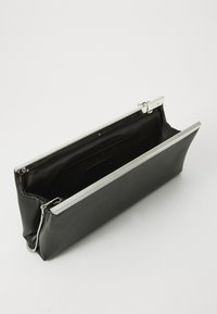 Black leather clutch bag with a silver metal frame. Interior features a single compartment and a card slot. Smooth texture throughout.