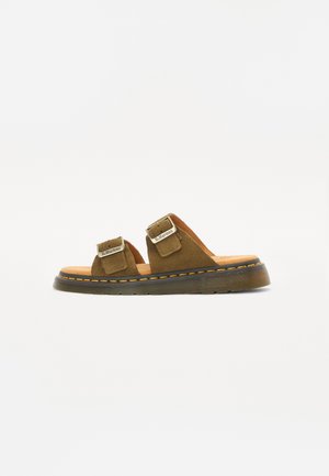Brown suede sandals with two adjustable straps, rubber sole, and contrasting yellow stitching along the edge. Flat design, open-toe style.
