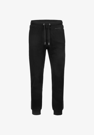 Czarne spodnie dresowe z elastycznym pasem, zapięciem na sznurek, bocznymi kieszeniami i ściągaczami na końcach nogawek. Gładki materiał z minimalnymi detalami brandingowymi.