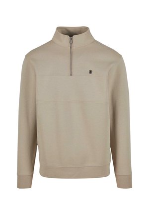 Beige sweatshirt med halv glidelås i kragen, lange ermer og en front søm detalj. Har en liten logo på brystet. Myk tekstur av stoffet.