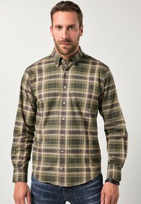 Overhemd met knopen in groen ruitpatroon met beige en bruine accenten. Beschikt over een verspreide kraag en lange mouwen. Gladde katoenstructuur.