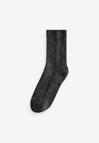 Svart ribbad strumpa med en texturerad design, som har inslag av vitt genom hela. Medellång med en standardresår upptill.