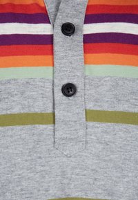 Grå kortærmet polo shirt med flerfarvede vandrette striber i orange, lilla, grøn og oliven. Har sorte plastknapper på stolpen.