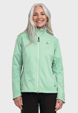Helle grüne Softshelljacke mit hohem Kragen, Frontreißverschluss und seitlichen Reißverschlusstaschen. Glatte Textur, taillierter Schnitt und dezentes Branding-Detail.