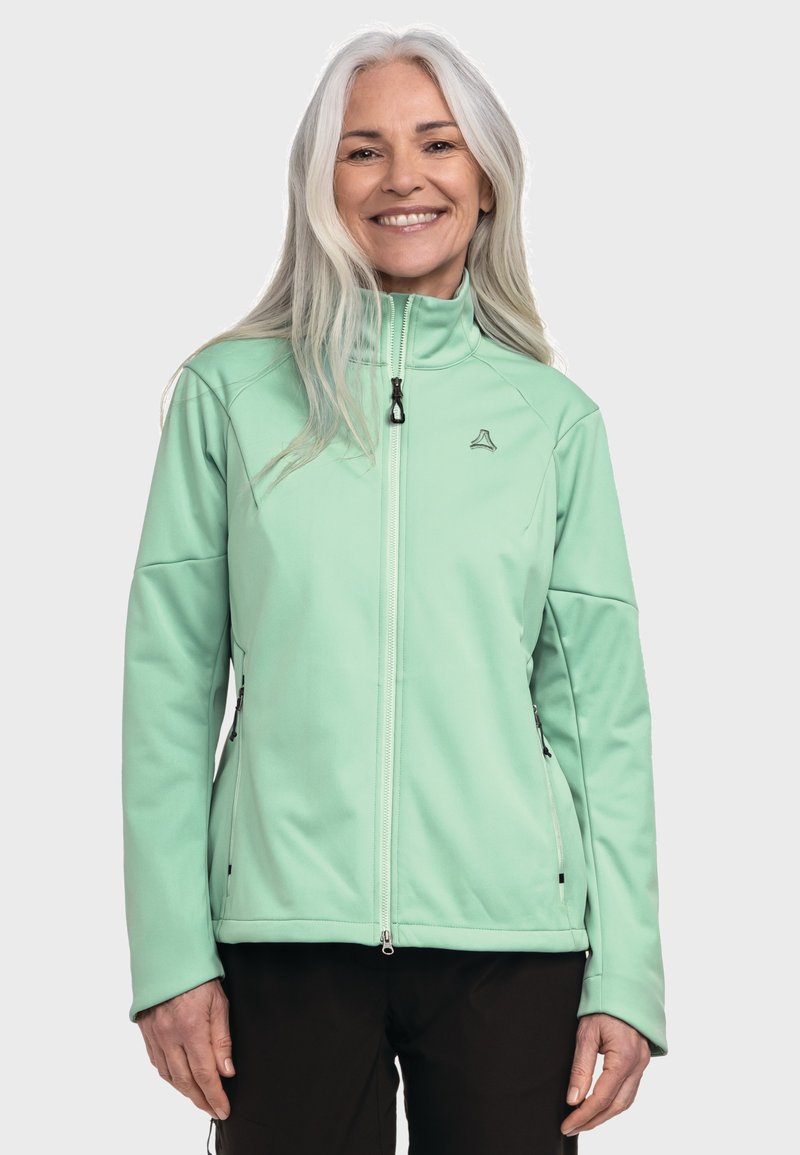 Helle grüne Softshelljacke mit hohem Kragen, Frontreißverschluss und seitlichen Reißverschlusstaschen. Glatte Textur, taillierter Schnitt und dezentes Branding-Detail.
