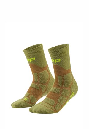Pair of green and brown cushioned crew socks with geometric patterns and yellow brand logo near the top and toes.
