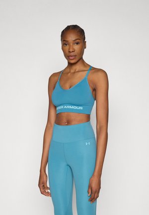 Turquoise athletic bra and matching high-waisted leggings, both made from smooth, stretchy fabric. Bra features "UNDER ARMOUR" logo on the band.