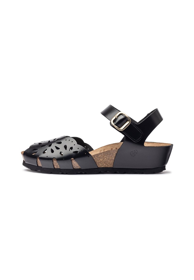 Black sandal featuring cut-out floral design, adjustable ankle strap, cork footbed, and textured rubber sole for traction.