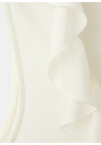 White fabric with a soft, flowing ruffle detail along the edge, showing texture and smooth layering.