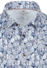 Kraagshirt met blauw-witte bloemenprint, bruine knopen en label met "DESOTO" in maat medium.