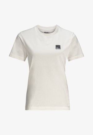 Vaalean kermaisen värinen puuvillainen t-paita, jossa on lyhyet hihat, pyöreä kaula-aukko ja pieni musta neliön muotoinen logo vasemmassa rinnassa. Silkkinen pinta, klassinen malli.