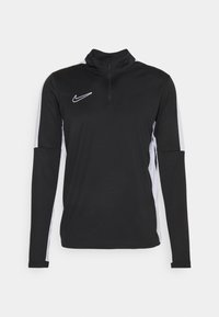 Black long-sleeve Nike top with a high collar and half zipper, featuring white side accents and a small logo on the chest. Made of smooth fabric.