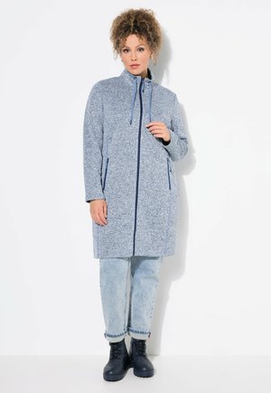 Blue zip-up coat with a high collar, two side pockets, and contrasting navy trim. Soft, textured fabric with a relaxed fit.