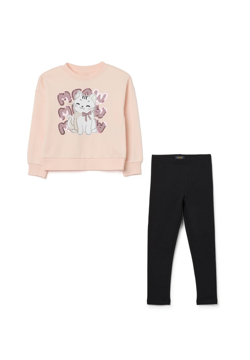 Sweatshirt rose clair avec un design de chat cartoon agrémenté d'accents pailletés, associé à des leggings stretch noirs. Matière en coton doux.