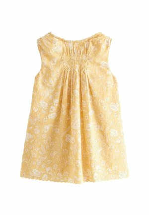 Robe bébé jaune sans manches avec motif floral blanc, smocks froncés au niveau de la poitrine et ourlet festonné sur fond blanc.