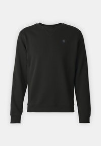 Felpa nera a maniche lunghe con collo a giro e polsini e orlo a costine, piccolo logo grigio sul lato sinistro del petto, design semplice.