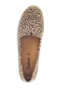 Chaussure slip-on à imprimé léopard avec une tige en tissu marron, bout rond et semelle plate. Présente une petite découpe à l'avant et un intérieur en tissu doux.