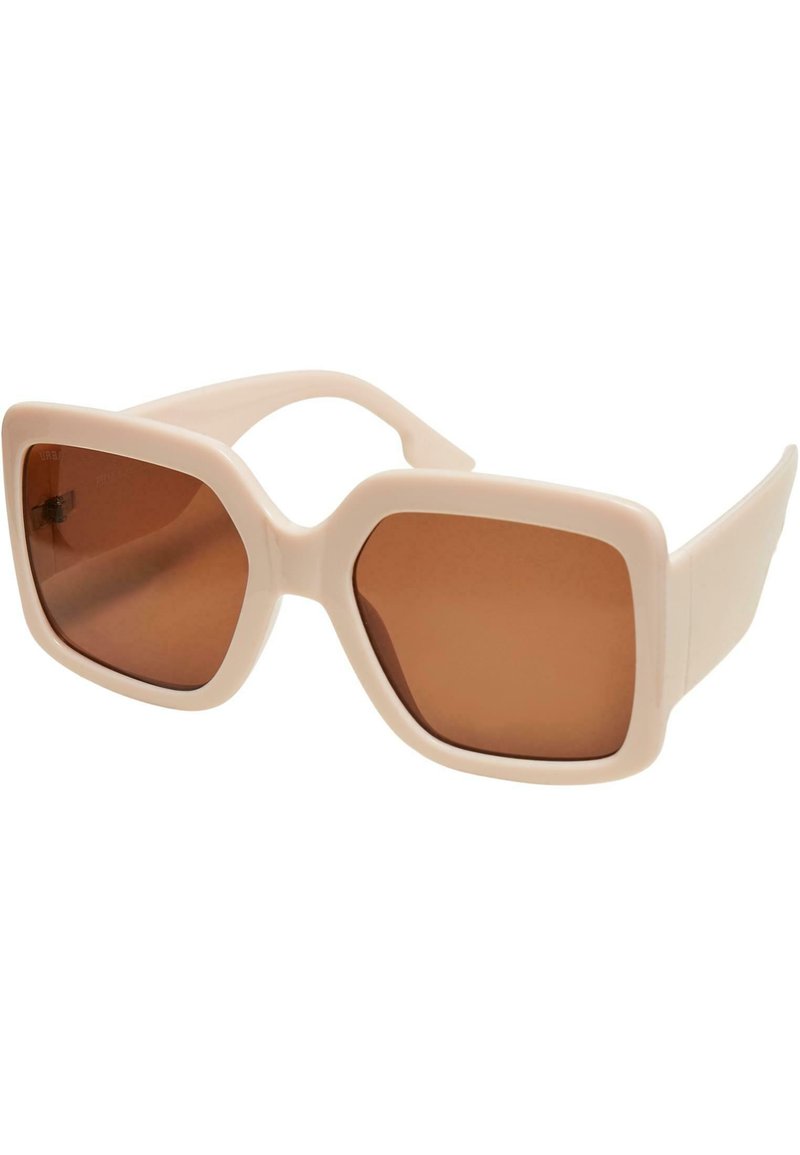 Ochelari de soare pătrați cu o montură roz pal, lentile maronii și un finisaj lucios. Prezentând brațe groase și un design minimalist.