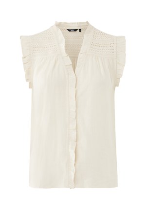 Blusa beige chiaro con maniche corte arricciate, scollo a V e delicati dettagli in pizzo sulle spalle. Presenta una chiusura con bottoni sul davanti e una texture morbida.