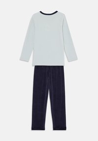 Light blue long-sleeve top with navy collar and soft dark blue fleece pants. Both pieces have a relaxed fit and smooth texture.