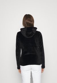 Black fleece hoodie with a soft texture, featuring a hood and long sleeves. Simple design with no visible hardware or patterns.