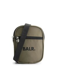 Olive green fabric crossbody bag with a textured surface, black zipper, and printed logo on the front. Adjustable black strap.
