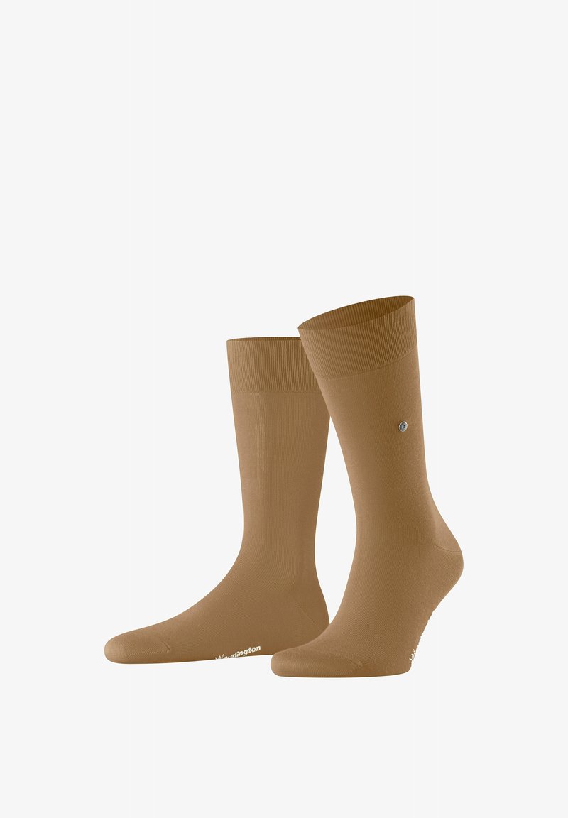 Chaussettes marron montantes jusqu'au genou avec un poignet côtelé, présentant une texture lisse et un petit logo sur la semelle. Fabriquées en matériau flexible.