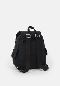 Black canvas backpack featuring adjustable brown straps, a roll-top design, zippered pocket, and side pockets for added storage.