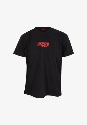 Sort bomulds T-shirt med rund hals. Har et rødt "STRANGER THINGS" logo centreret på brystet, med fed skrifttype og takkede kanter.
