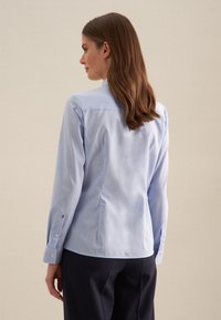  Lichtblauwe, lange mouwen shirt met een gladde textuur, knoopmanchetten en een getailleerd ontwerp aan de achterkant. Heeft een klassieke kraag en subtiele naden.