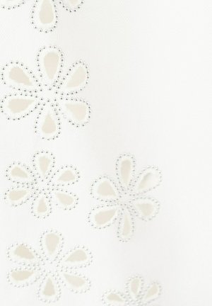 Surface blanche avec des contours de perles argentées formant des motifs floraux avec des pétales en forme de goutte dans une disposition dispersée.
