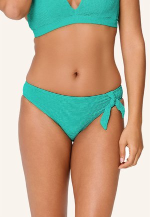 Il bikini bottom turchese presenta un tessuto testurizzato con un design a vita alta e un accento a nodo laterale. Materiale liscio e elastico con un dettaglio giocoso.