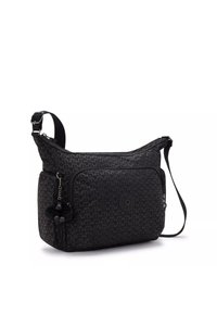 Black patterned crossbody bag, made from durable fabric; features a zip closure, adjustable strap, and small pom-pom keychain accessory.