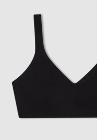 Reggiseno wireless nero con design a V, realizzato in tessuto morbido. Presenta sottili spalline regolabili e una costruzione senza cuciture.