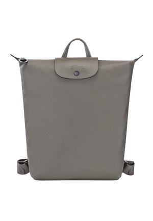 Gray leather backpack with a rectangular shape, top handle, zip closure, and adjustable straps. Features a subtle logo on the flap.
