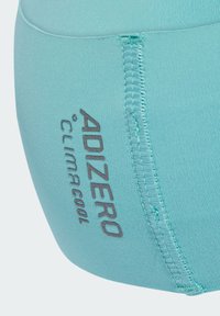 Turkusowe elastyczne szorty sportowe o gładkiej fakturze, z widocznym logo "ADIZERO CLIMACOOL" w kolorze srebrnym i widocznymi detalami szwów.