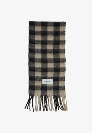 Écharpe en mélange de laine avec un motif à carreaux noir et beige, bordée de franges et dotée d'une étiquette blanche cousue.