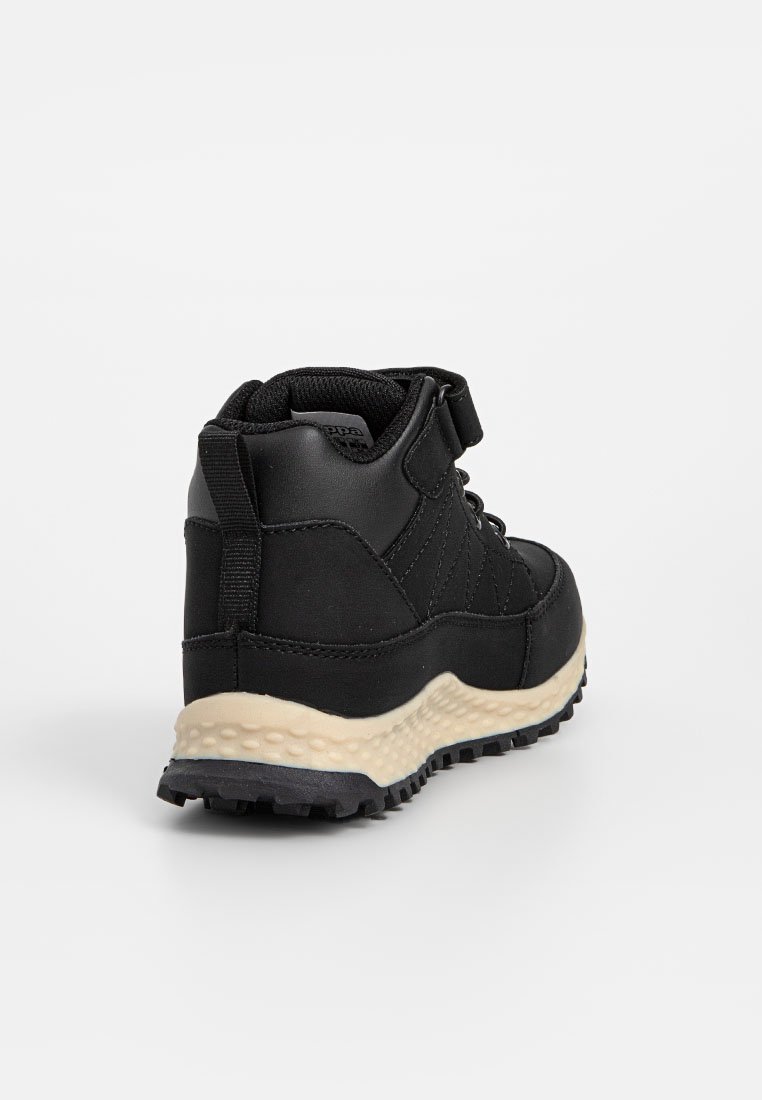 Botte de randonnée noire avec semelle beige texturée, col de cheville rembourré, langue à l'arrière et fermeture à lacets avec une sangle Velcro.