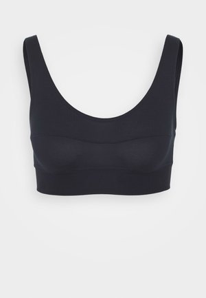 Bralette noir sans couture avec un décolleté arrondi, des bretelles larges et une texture lisse et ajustée. Fabriqué en tissu extensible et doux.