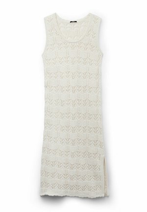 Sleeveless, knee-length dress made of cream-colored lace knit featuring a wavy pattern and side slits for flexibility.