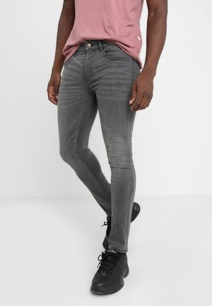 Grijze slim-fit jeans van denim, met vijf zakken, een knoopsluiting aan de voorkant en subtiele vervaging op de benen.