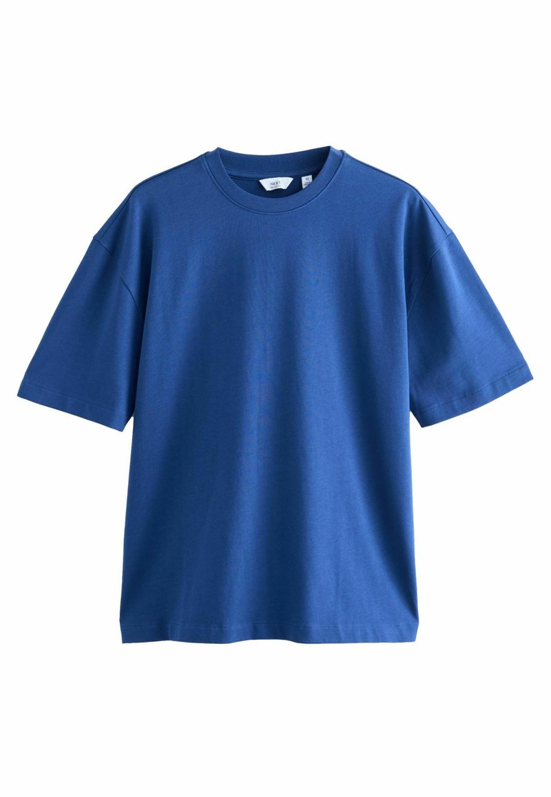 Camiseta de algodón azul con mangas cortas, cuello redondo y corte relajado. Textura suave sin patrones ni adornos visibles.