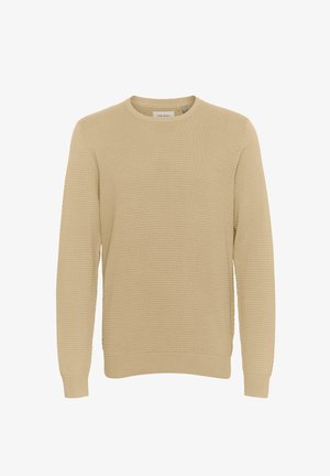 Bežinė megzta palaidinė su tekstūriniu raštu, apvaliu iškirpimu ir glaustomis rankovėmis. Sukurta laisvai priglundančiam siluetui, tinkama kasdieniam dėvėjimui.