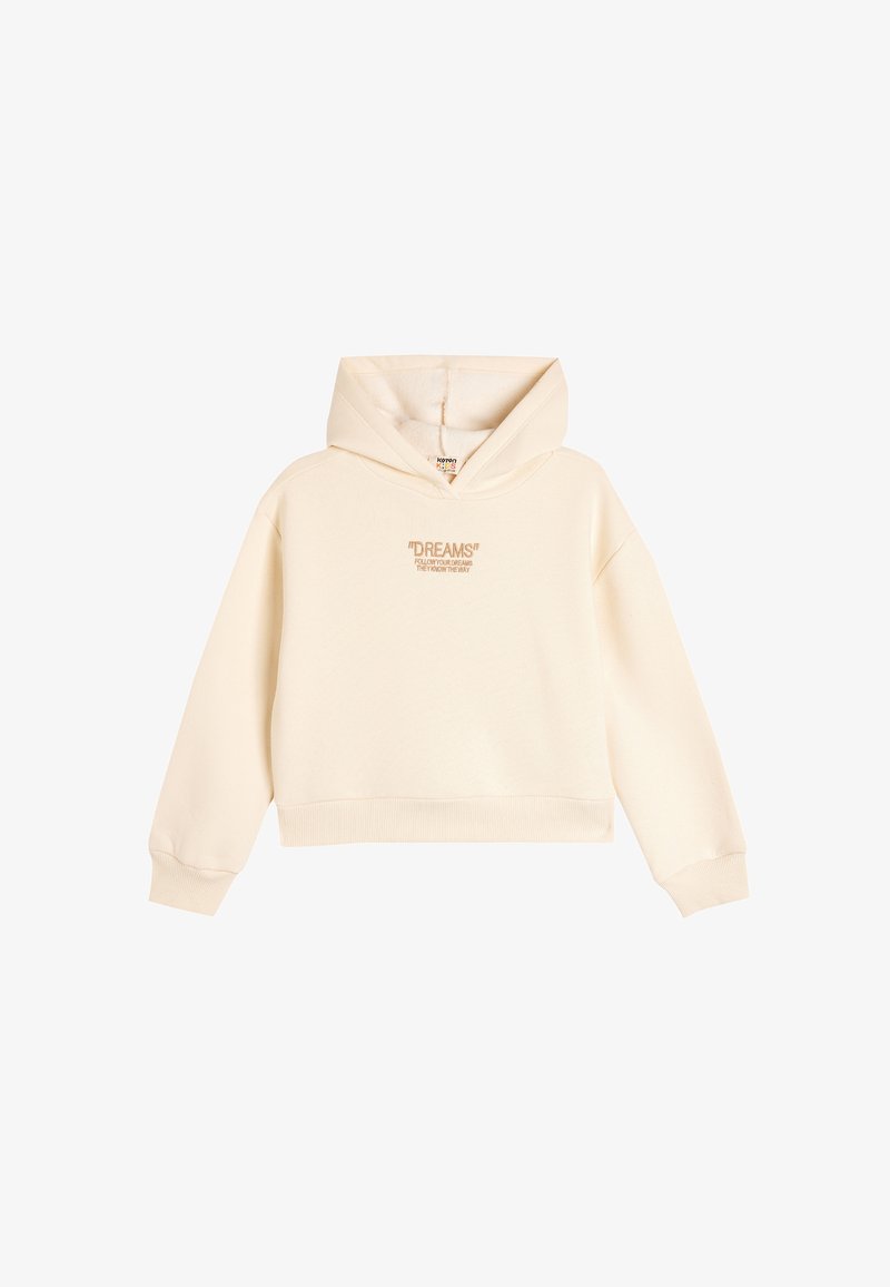 Sudadera corta de color crema con capucha, que presenta un bordado frontal que dice "¡SUEÑOS!" en un color que contrasta. Tejido suave y puños acanalados.